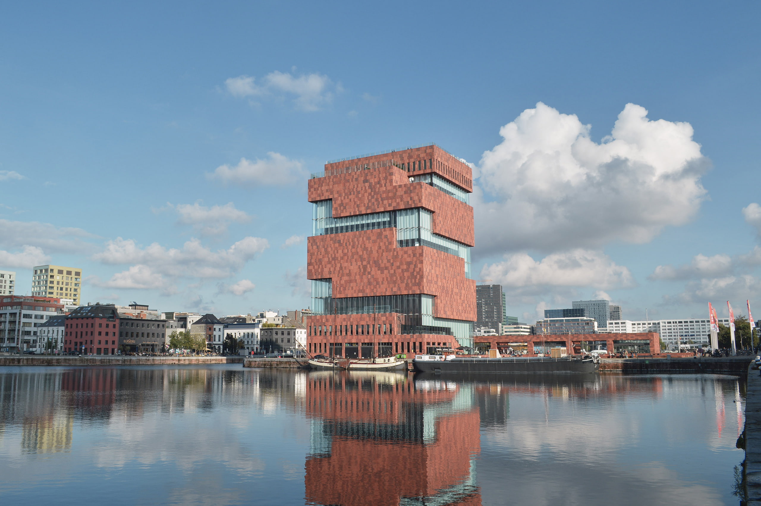 Modern apartment building near harbor on sunny day