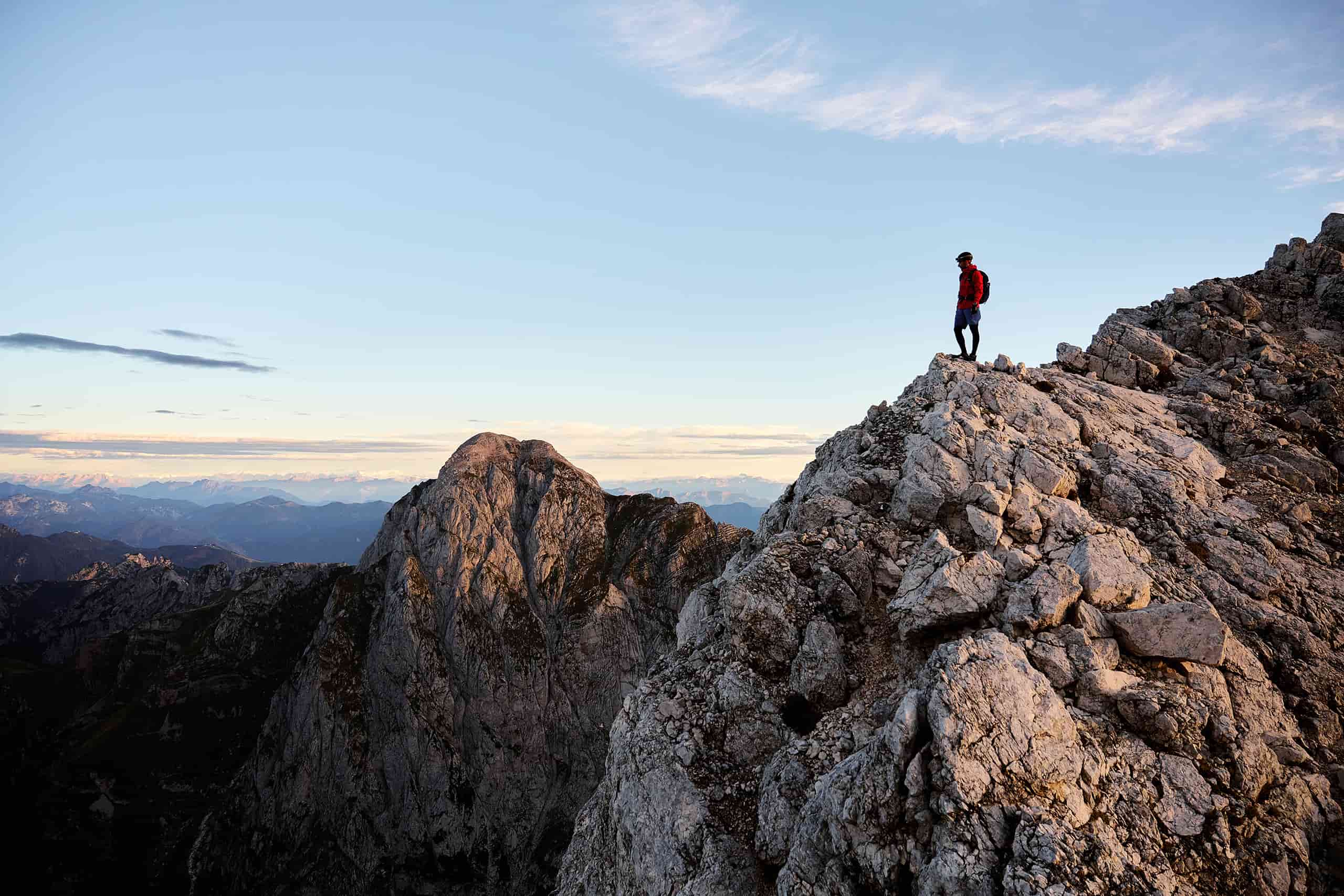 man looking out over rugged mountain peaks