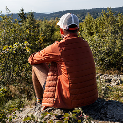 man sitting on rock