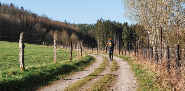 man hiking on unpaved path