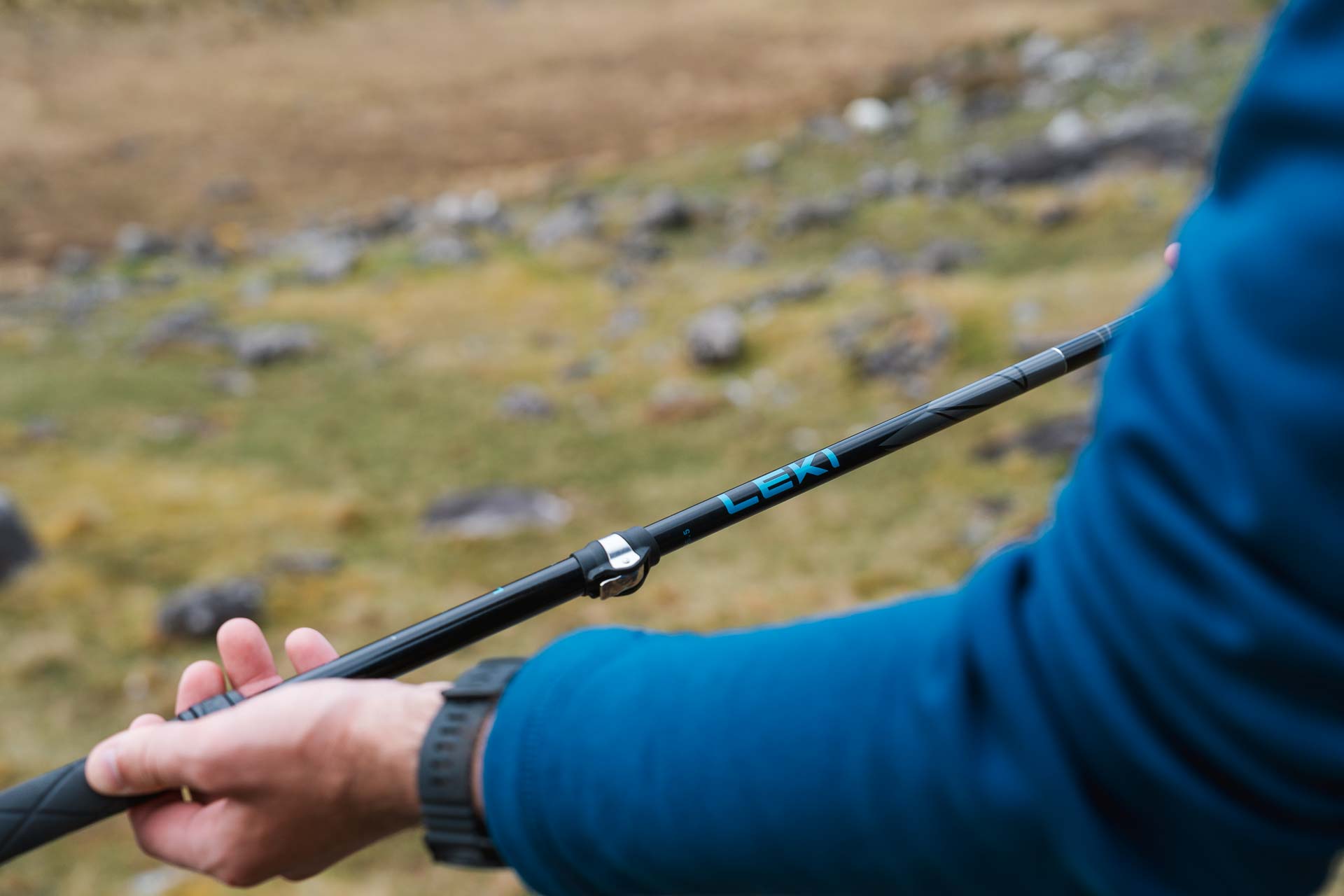 man holding his hiking poles