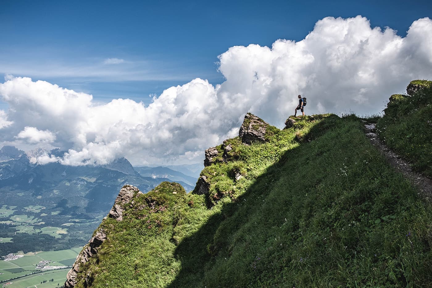 man standing on top of mountain